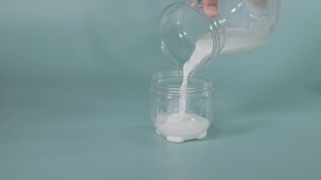 Milk being poured into a yogurt fermentation container