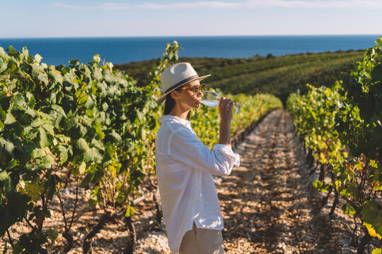 Woman enjoying wine with sea view