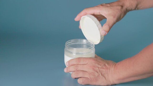 Opening the lid of a fermented yogurt container