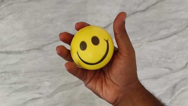 Adult person hand palm holding malleable stress ball and fingers squeezing, squashes or pressing to release tension while blood donation. Anxiety disorder, grip strength or mental relaxation concept.