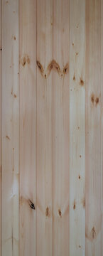Light brown vertical wooden planks background texture with natural wood grain and knots