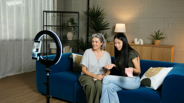 Grandmother and granddaughter vlogging makeup tutorial with ring light