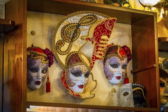 Venetian carnival masks in a shop window, Venice, Veneto, Italy
