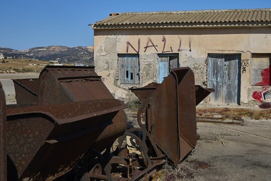 Abandoned graffiti-covered building and rusty machinery in a desert-like environment, saltworks, Lost Place, near airport, salt lake, Alykes Milou, Milos, Cyclades, Greek Islands, Greece