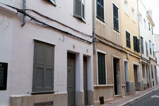 Mahon street with colorful buildings and closed shutters