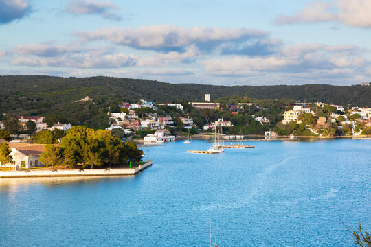 Mahon harbor waterfront with boats and town