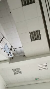 Overhead office ceiling panels, white acoustic tiles, clean modern corporate