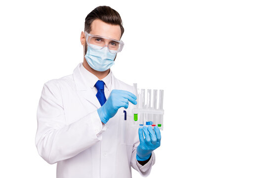 Portrait of his he nice attractive smart clever doc surgeon holding in hands bulbs making virus reaction analysis lab creating new drug remedy isolated on light white gray pastel color background