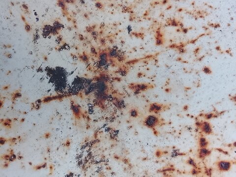 Rust texture on white painted metal surface with corrosion spots