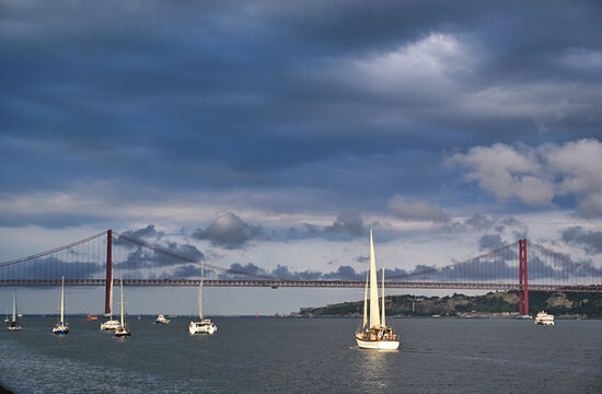 Sailing Boats on Tagus River in Front of 25 de Abril Bridge in Lisbon, Portugal