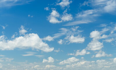 Obraz premium Fluffy white clouds on a bright blue sky background