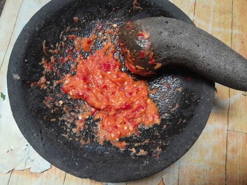 grinding cooking spices in a mortar