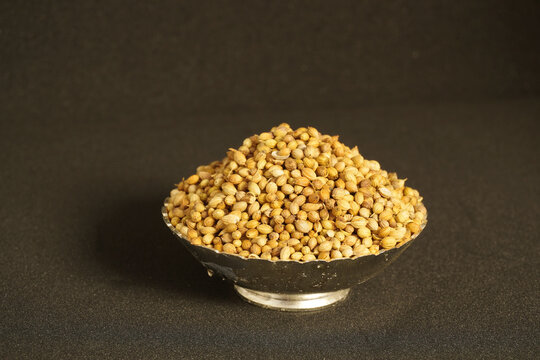 Close up of dried coriander seeds in bowl forming a natural spice 