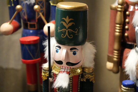 Traditional nutcracker figure in a green and gold shako