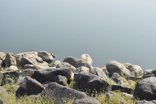 Rocks along the Selorejo Dam in Malang Regency. Ideal for nature, coastal, or geology themes.