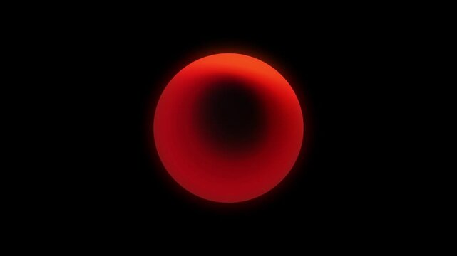 Vibrant red orb illuminated by warm light against dark background