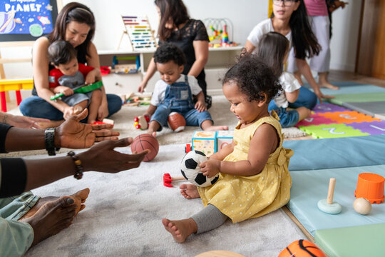 Diverse toddlers playing joyfully together.