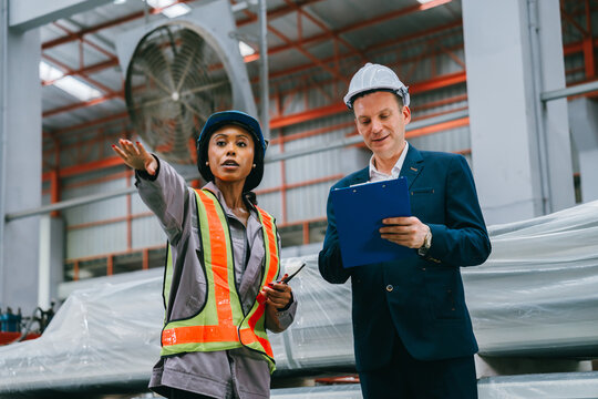 Industrial concept metal sheet factory engineer in an industrial plant showing satisfied emotion with professional teamwork in building