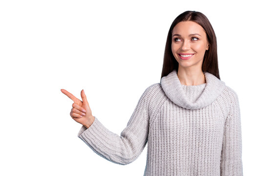 Portrait of positive funny funky gilr point index finger look at ads adverts promotion w ear white knitted clothes sweater isolated over blue color background