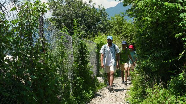 Male hiker walks along a narrow gravel path near the Kedarnath Temple in Rudraprayag Uttarakhand