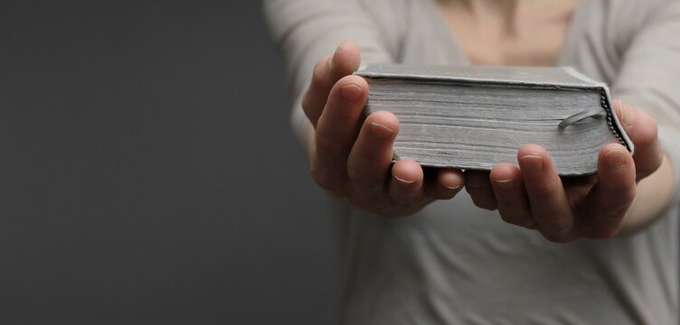 praying to god with hands on bible religious showing faith with God woman praying with background with people stock photo stock image