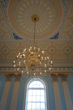 Gold chandelier and neoclassical ceiling detail in Newark England