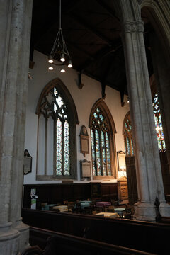 Church interior with cafe seating below stained glass Newark