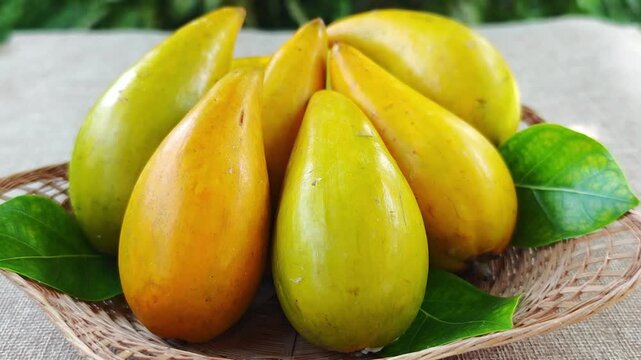 Fresh santol fruits on a bamboo basket