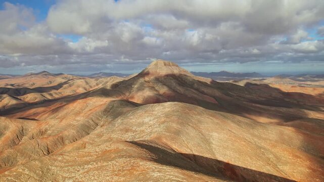 Aerial view of desert landscape near Mirador Sicasumbre and Montana de Melindraga at sunset, Fuerteventura island, Spain. 2x speeded up from 30 fps.