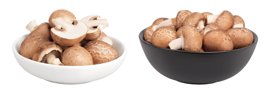 Brown champignon mushroom in a ceramic bowl isolated on white background