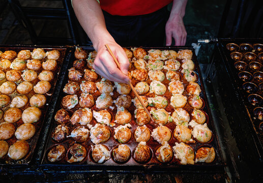 Takoyaki cooking on hot pan Osaka street food Japanese Culture 