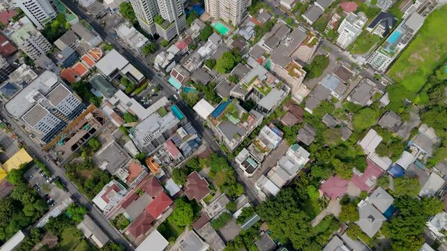 Breathtaking bird eye view captures the sprawling city life, lush canopy and tall structures basking under the bright daylight rays