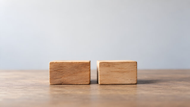 Two wooden blocks separated by a narrow gap symbolizing negotiation deadlock