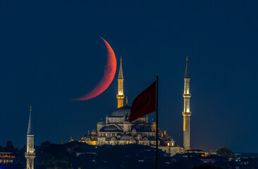 Fatih Mosque and the crescent moon together in a long-exposure night photo. © kenan