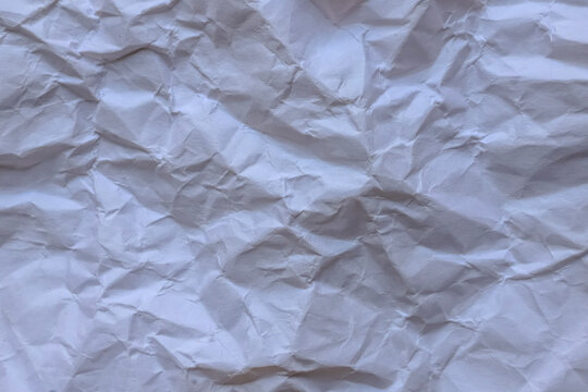 Crumpled off-white paper texture background with soft natural lighting and warm undertones