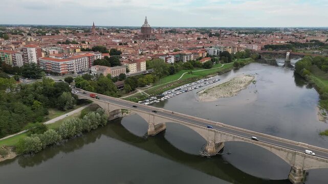 Europe, Italy, Pavia &ndash; drone views of the Ticino River, dried up due to drought and aridity - global warming and climate change in Ponte Coperto , Duomo cathedral and bridge with traffic car 