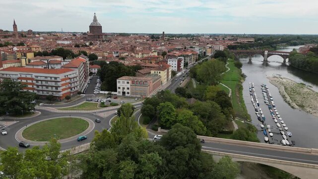 Europe, Italy, Pavia &ndash; drone views of the Ticino River, dried up due to drought and aridity - global warming and climate change in Ponte Coperto , Duomo cathedral and bridge with traffic car 