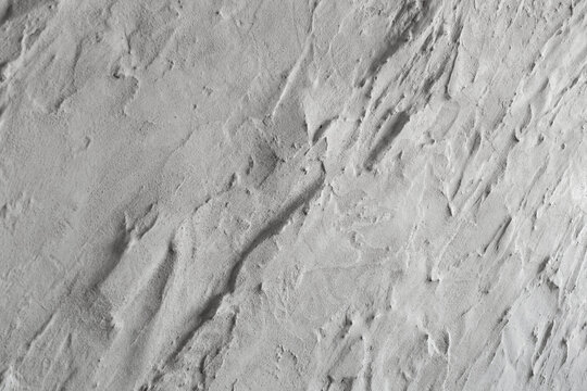 Abstract white decorative plaster texture wall with natural irregular surface and subtle relief