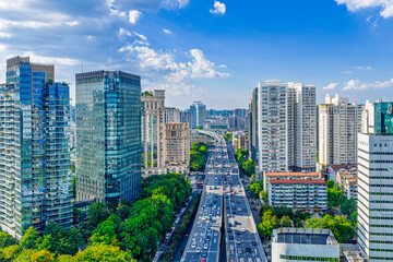 Modern city high rise buildings and traffic under blue sky © tangfangxiao