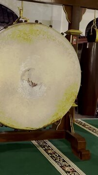 Traditional Indonesian bedug drum displayed on wooden frame