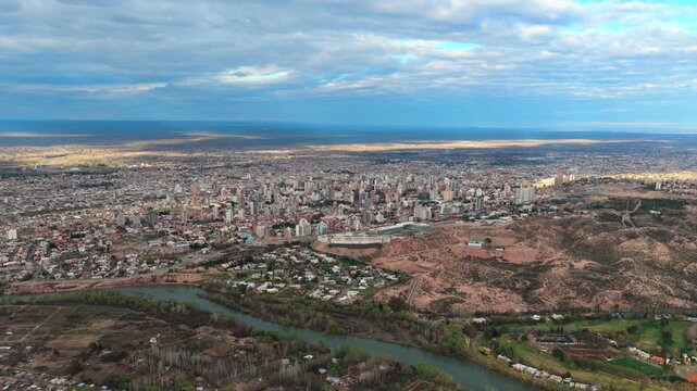Aerial drone shot of Neuquen city skyline at the confluence of the Limay and Neuquen rivers, Argentina.