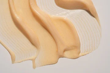 Gold shimmer body cream swatch texture. Shiny beige liquid lotion smudge, glittering skincare moisturizer or cosmetics gel highlighter sample © IKvyatkovskaya