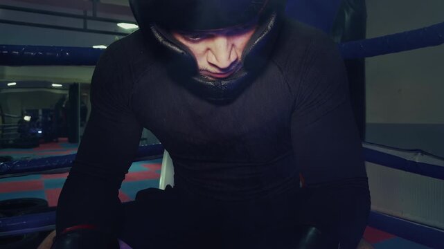 Tired Fighter in Headgear Sitting Between Rounds