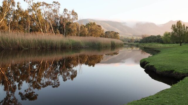 sunrise over beautiful reflections in the Klein River and Klein Mountains, Stanford, South Africa