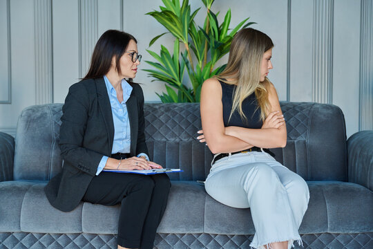 Offended young woman ignoring female therapist during consultation