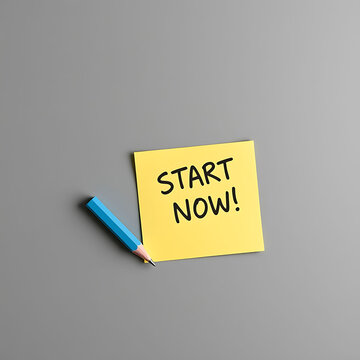 A yellow sticky note with the text start now written on it with a blue pencil beside it