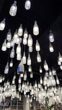 Champagne bottle lanterns hanging from the ceiling. Champagne tasting, Christmas in Reims, Champagne, France, December 25, 2025. High quality 4k footage