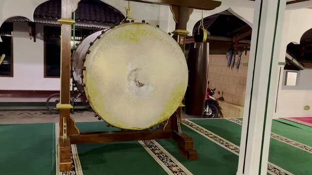 Traditional Indonesian bedug drum displayed on wooden ceremonial frame