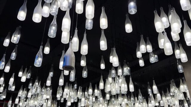 Champagne bottle lanterns hanging from the ceiling. Champagne tasting, Christmas in Reims, Champagne, France, December 25, 2025. High quality 4k footage