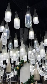 Champagne bottle lanterns hanging from the ceiling. Champagne tasting, Christmas in Reims, Champagne, France, December 25, 2025. High quality 4k footage